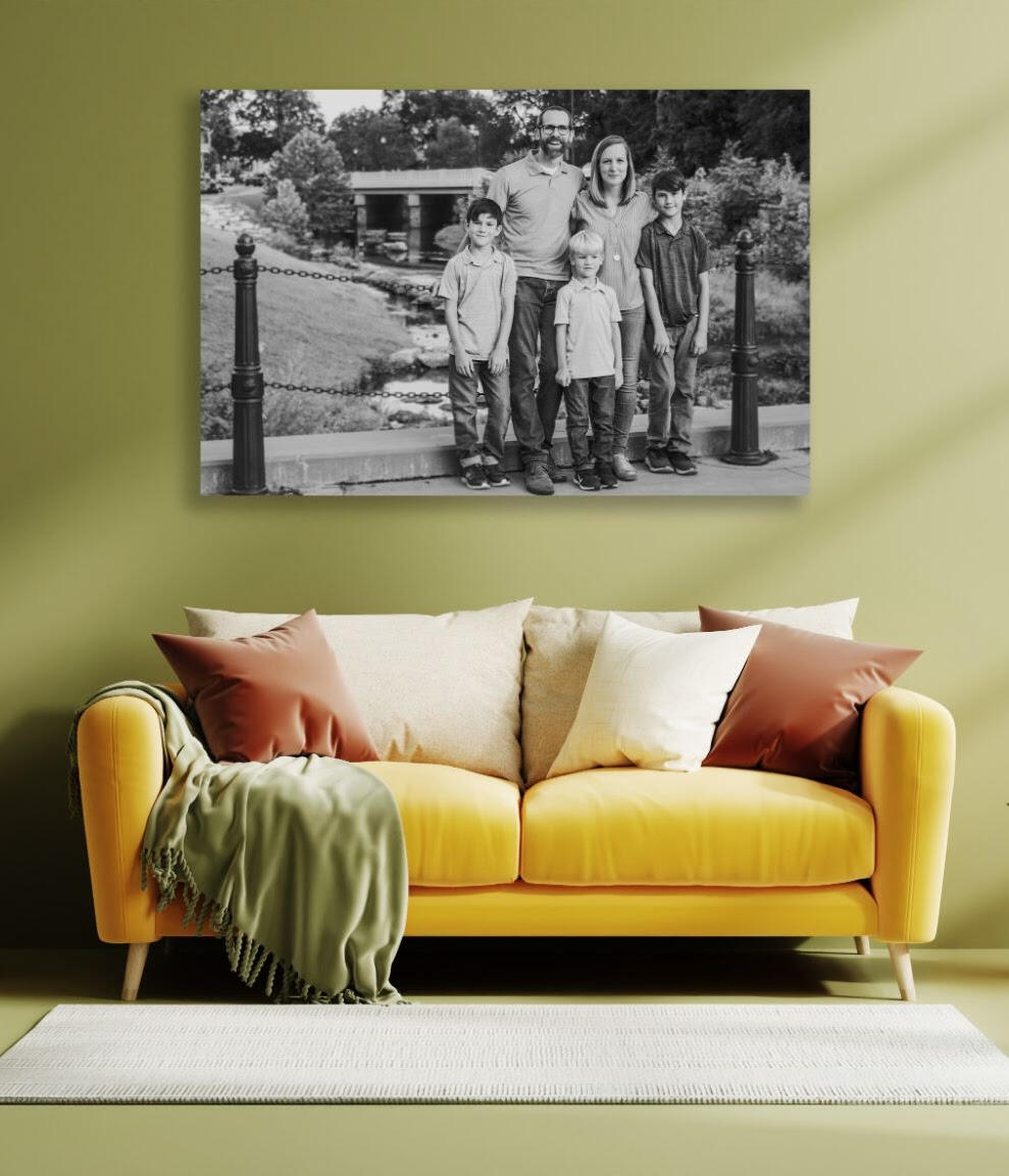 A framed Unspoken Art family photo hangs on the wall of an upscale living room in the Capital Region
