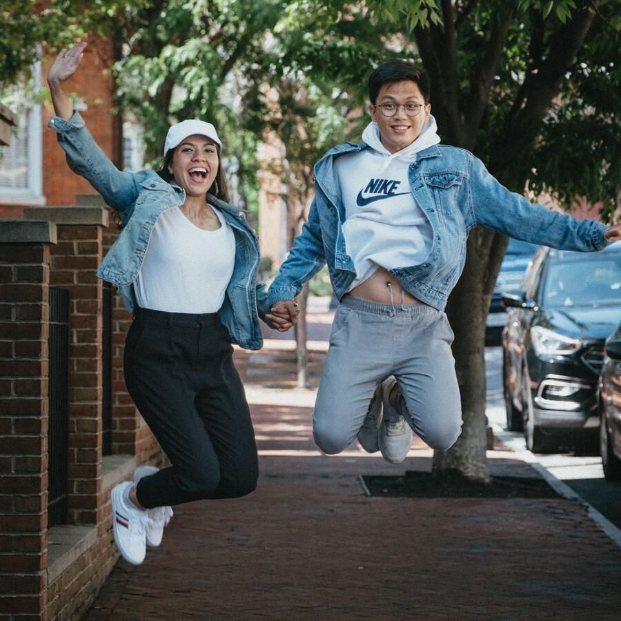 An Unspoken Art photo of a cute couple jumping into the air holding hands